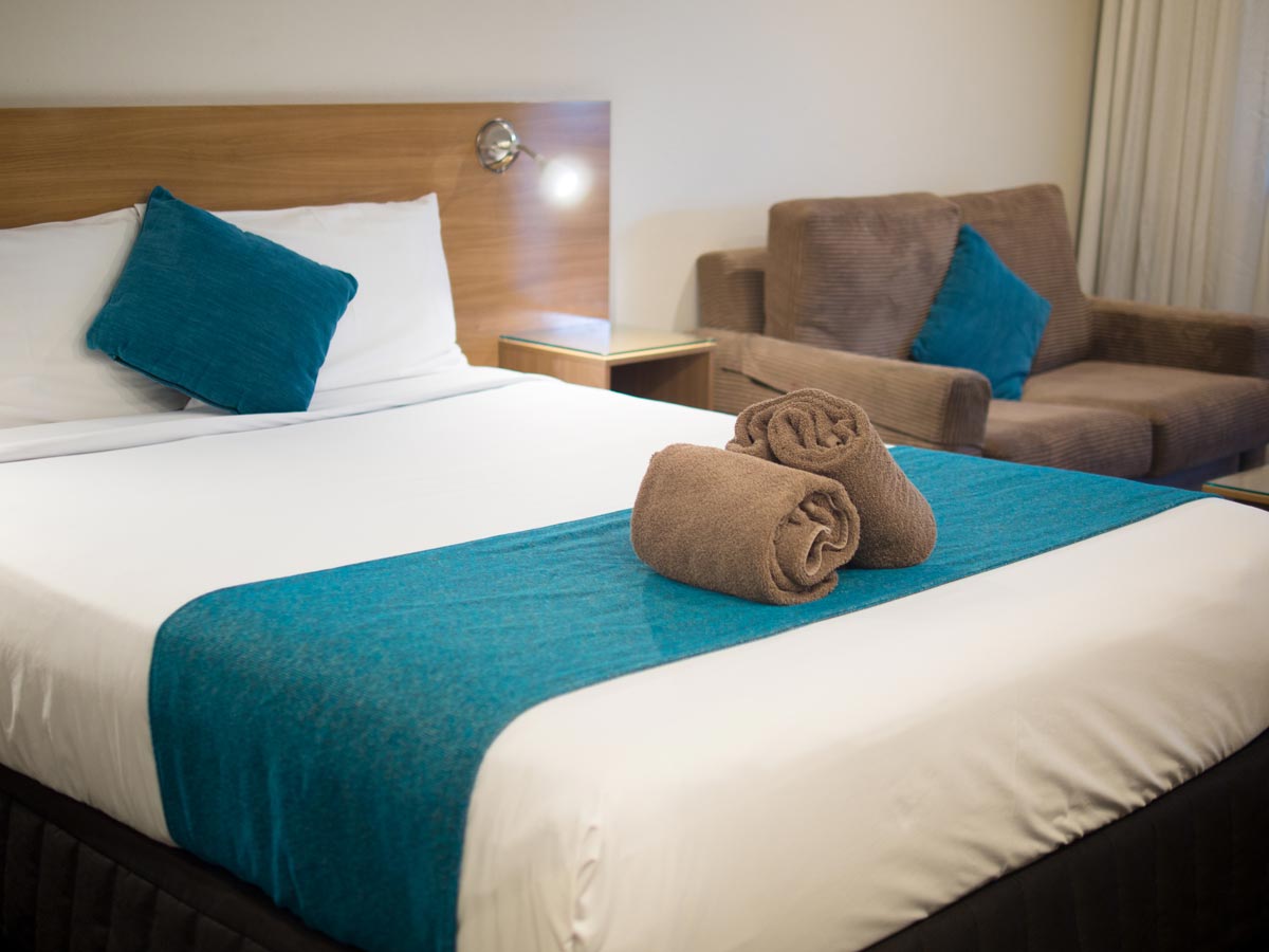 Executive Rooms — Bed and sofa